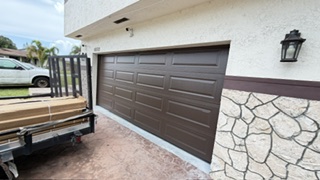 Brown raised-panel garage door installation on a Florida home
