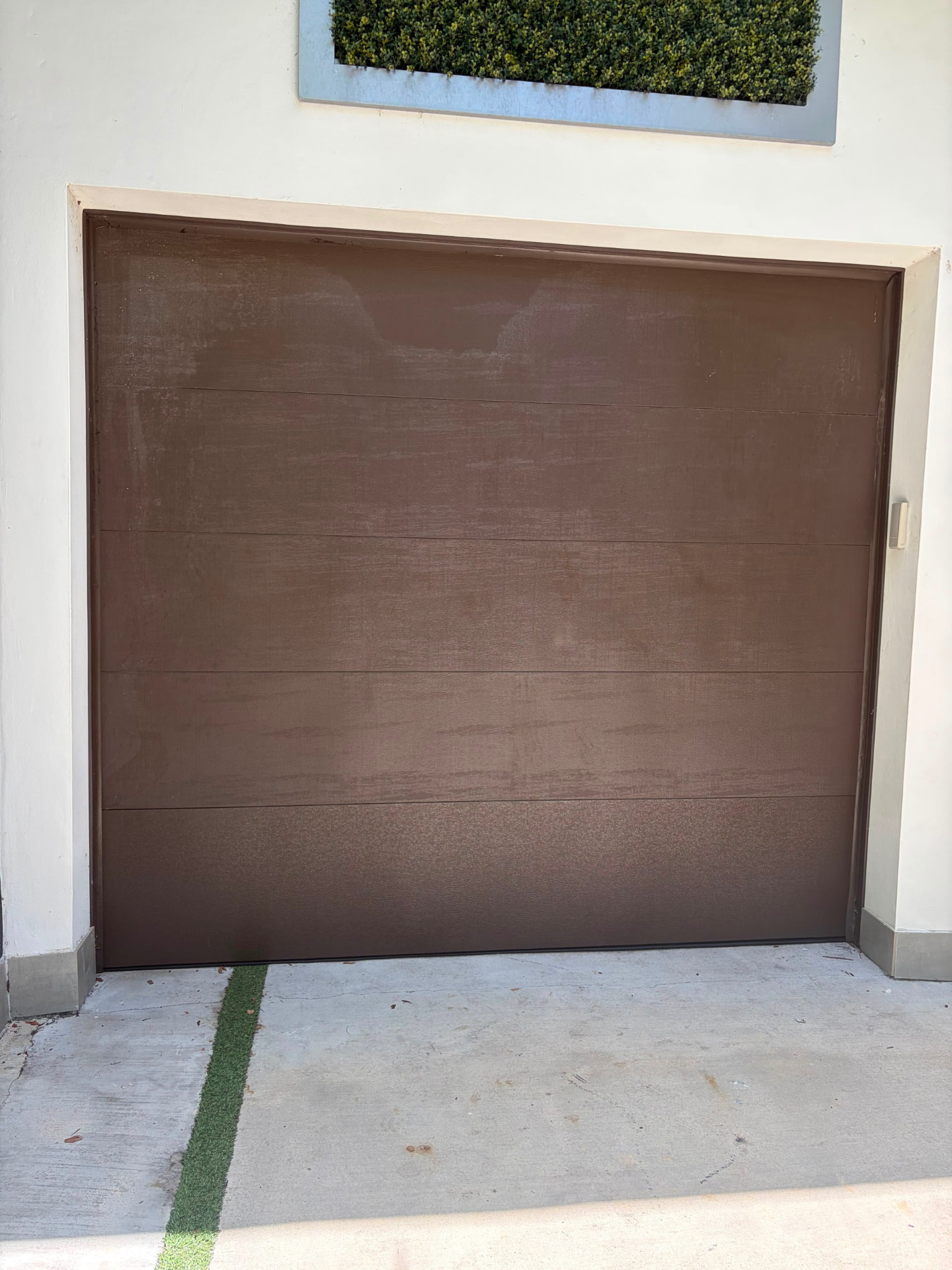 Bronze woodgrain single car garage door installation