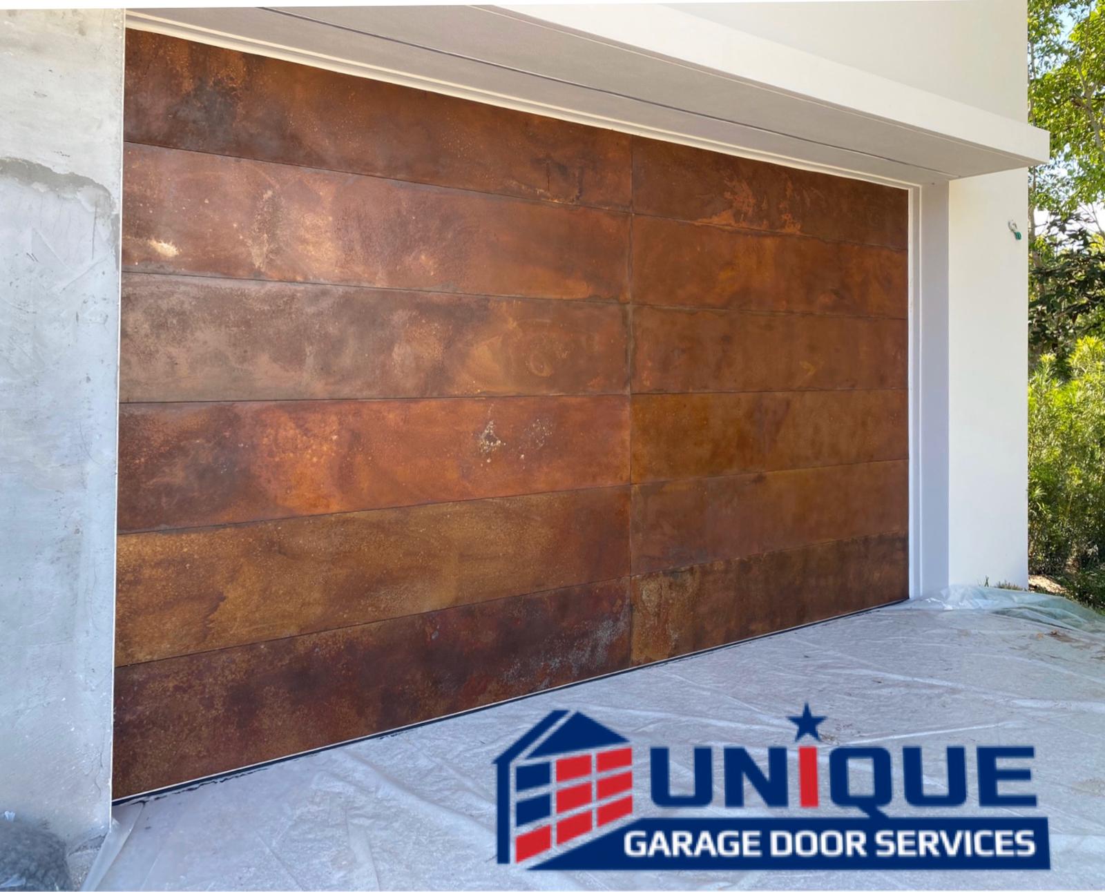 Custom copper patina finish garage door installed by Unique Garage Door Services